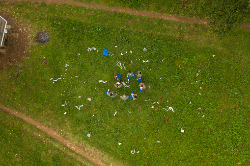 Aerial view of volunteers in matching outfits cleaning public park