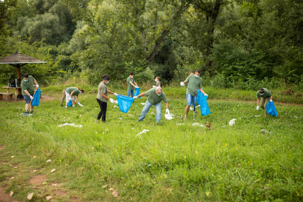 istock Volunteers team cleaning public park together 1265004276