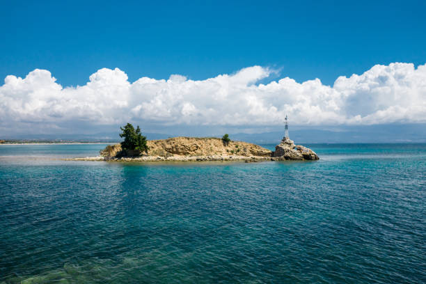 istock Rock in the sea with small lighthouse. 1265004501