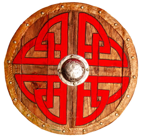 istock Viking round wooden brown shield decorated with a rough red-black pattern and metallic and copper protective elements 1265006912