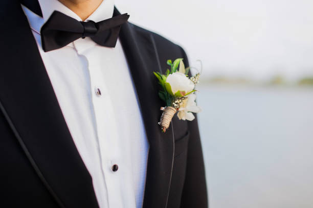 istock black tuxedo and boutonniere, groom 1265008285