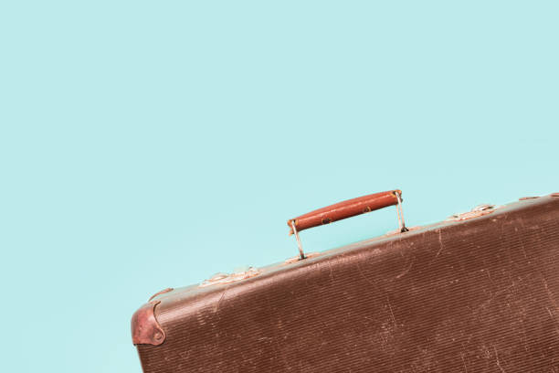 istock Retro old suitcase on blue background copy space top view Travel concept 1265008682