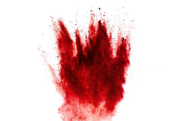 istock Red powder explosion on black background. Freeze motion of red dust particles splash. 1265009500
