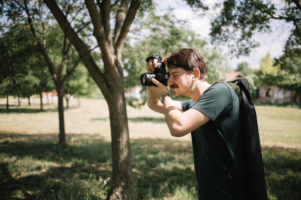 istock Photographer photo shooting in nature using professional camera 1265010213