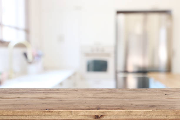 istock empty table board and defocused modern kitchen background. product display and picnic concept 1265010346