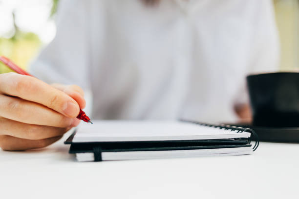 istock Close-up of a woman making notes 1265012923