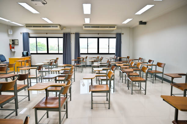 istock Empty classroom no teachers and students with chairs and desks 1265014106