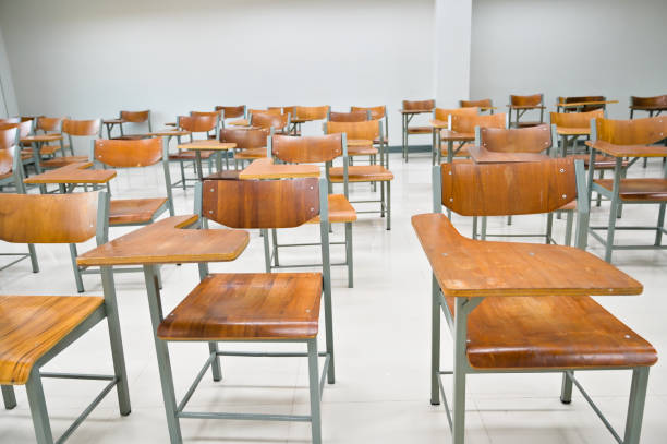 istock Empty classroom no teachers and students with chairs and desks 1265014108