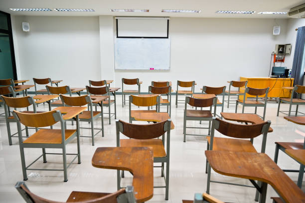 istock Empty classroom no teachers and students with chairs and desks 1265014115