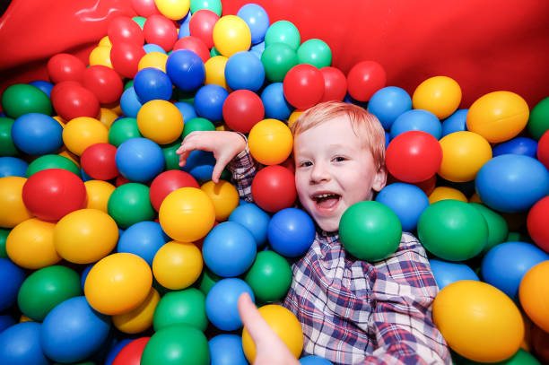 istock Blond boy palying in a ball pool 1265014519