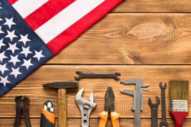 istock Labor day. American flag and various tools on a wooden table. 1265014687