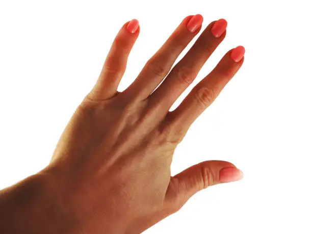 Pink manicure on a woman's hand on a white background. Isolated object.