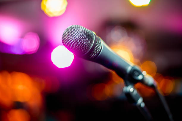 istock close-up stage microphone with blurry lights in the background 1265016270