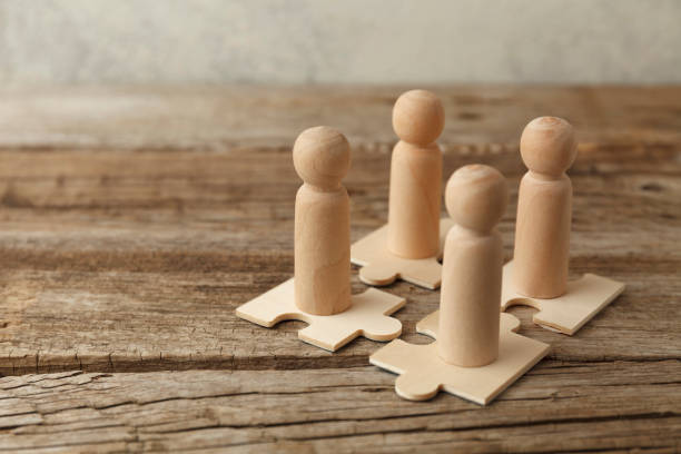 istock Wooden figures on puzzles. People analytics and optimization, team building. Group connection in business 1265017355
