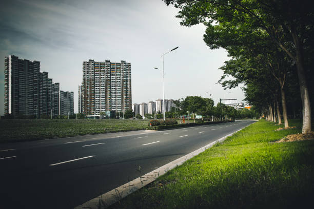 istock Clear sky, urban buildings, roads by dense woods 1265017697