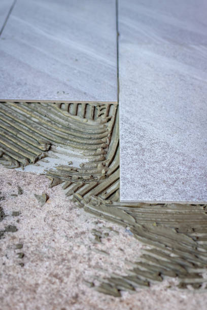 istock Tile installation with glue on concrete floor 1265019078