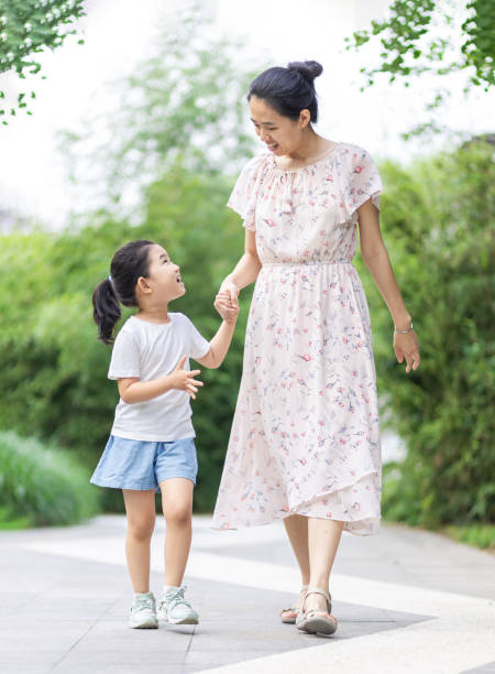 istock Mom and daughter walking and talking 1265019828