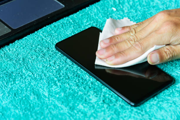 istock cleaning mobile phone screen by microfiber cloth. Before apply the smart phone screen protect flim 1265020465