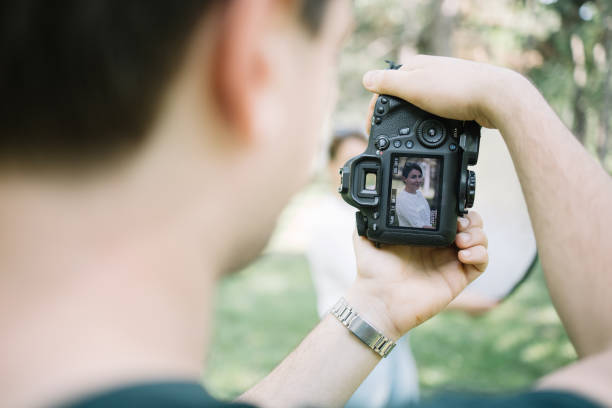 istock Blurred man holding camera with girl in camera's display 1265026946