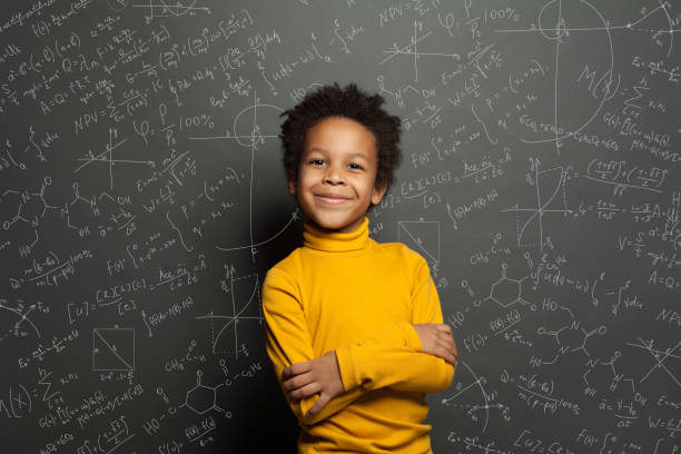 istock Smart African American child student boy on chalkboard background with science formulas 1265028884