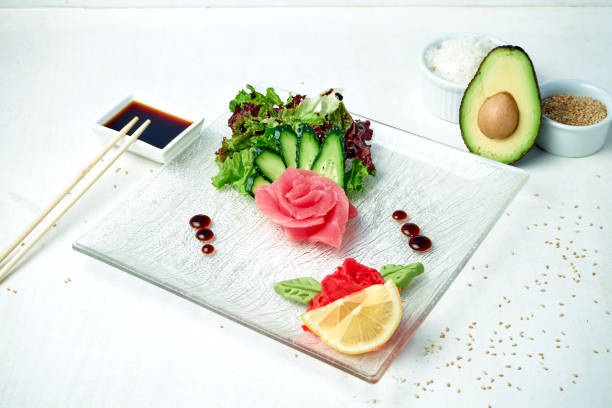 istock Classic Japanese sashimi - tuna with salad on a white plate in a composition with ingredients 1265029121
