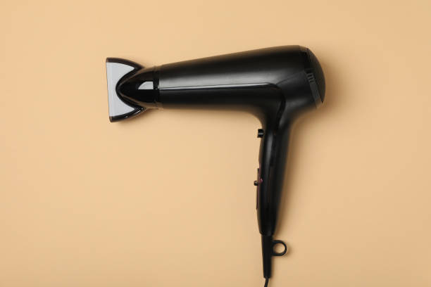istock Black hair dryer on beige background, space for text 1265030203