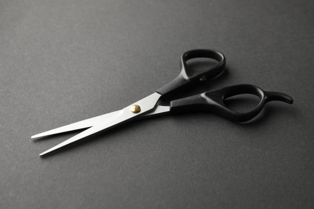 istock Black hairdresser scissors on black background, space for text 1265030951