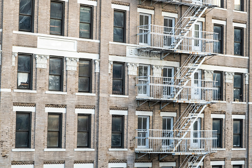 Catherine Street’s classic low-rise walkups with fire escapes built in early 1900s and located near East River between Brooklyn and Manhattan Bridges, New York city