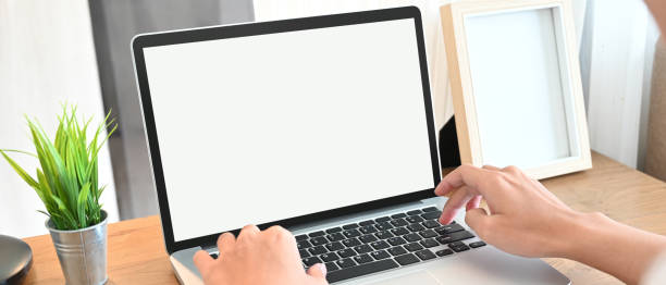istock Cropped image of hands is using a computer laptop at the wooden working desk. 1265033564