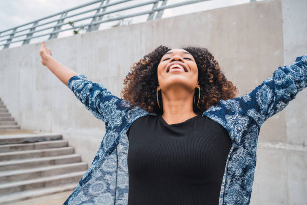 istock Afro american woman with arms raised. 1265033897