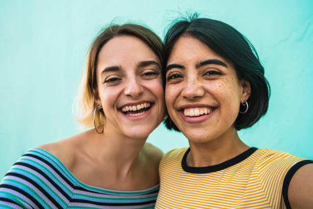 istock Lovely lesbian couple taking a selfie. 1265033933