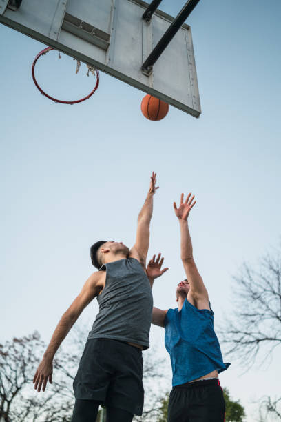 istock Two young friends playing basketball. 1265033951