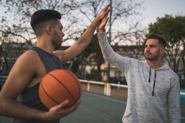 istock Two young friends playing basketball. 1265033966