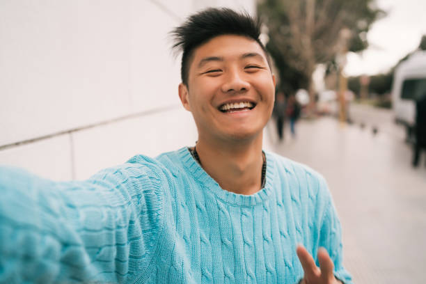 istock Asian man taking a selfie. 1265033970