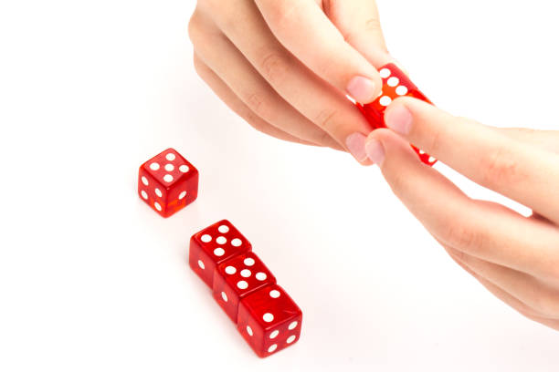 istock Transparent and red glass dices in hand isolated on white background. 1265034015