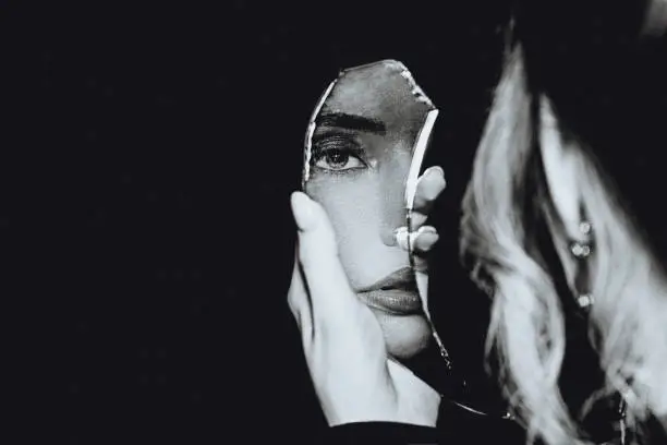 Photo of Black and white portrait of woman and broken self-image mirror