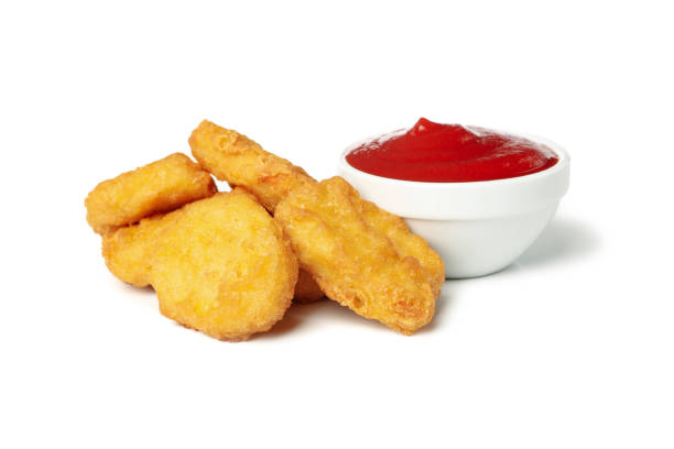 istock Fried crispy chicken nuggets and ketchup isolated on white background 1265035765