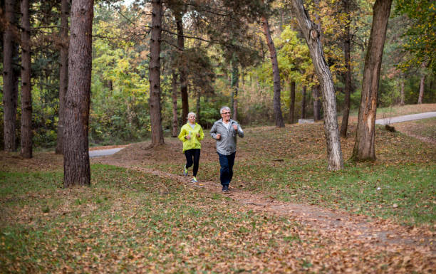istock Senior couple jogging in a forest. 1265036604