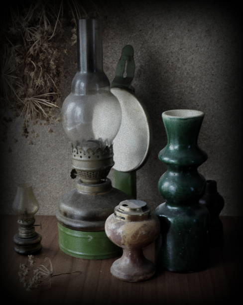 istock Still life with kerosene lamps, a vase and a lighter. Old dusty objects. 1265036917