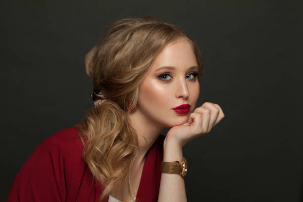istock Nice woman with handwatch on black banner background 1265040147