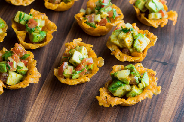 Guacamole. Spicy Guacamole served in crispy taco shells with salsas, cilantro and lime. Avocados diced and mixed with lemon and lime juices. Classic Tex-Mex, Mexican or American restaurant appetizer favorite. Spicy Guacamole served in crispy taco shells with salsas, cilantro and lime. Avocados diced and mixed with lemon and lime juices. Classic Tex-Mex, Mexican or American restaurant appetizer favorite. mex mexican restaurant tex stock pictures, royalty-free photos & images