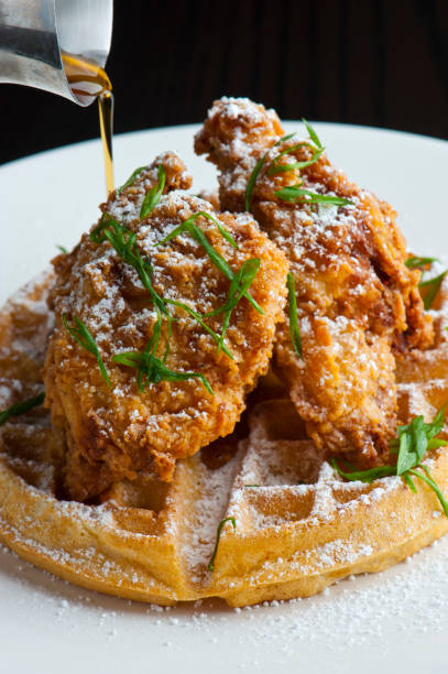 istock Chicken & waffles. Waffles w/ fried chicken. Homemade Waffles w/ crispy chicken butter & maple syrup. Classic American breakfast or brunch favorite. Made from scratch Waffles  w/ chicken, butter & maple syrup. 1265040865