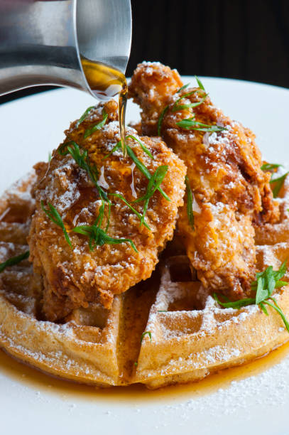 chicken & waffles. waffles w/ fried chicken. homemade waffles w/ crispy chicken butter & maple syrup. classic american breakfast or brunch favorite. made from scratch waffles  w/ chicken, butter & maple syrup. - waffle imagens e fotografias de stock