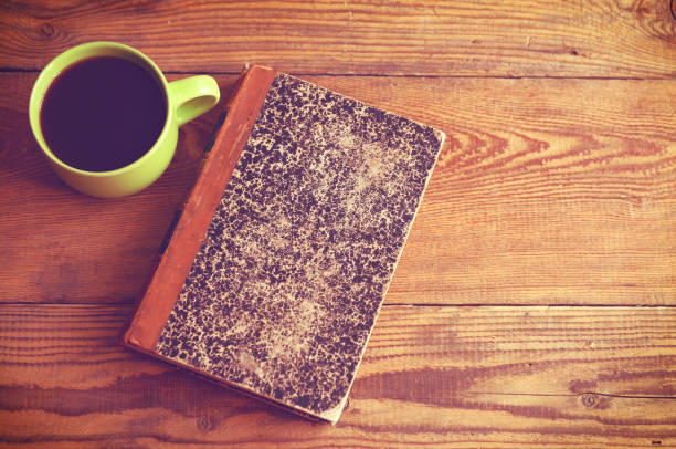 old book and coffee on a wooden table