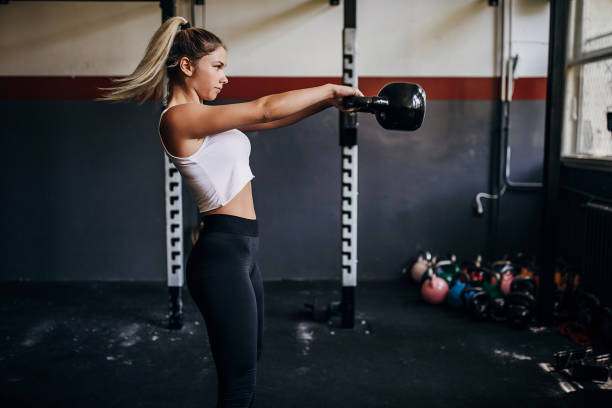 istock Female athlete training with kettlebell in the gym 1265042275