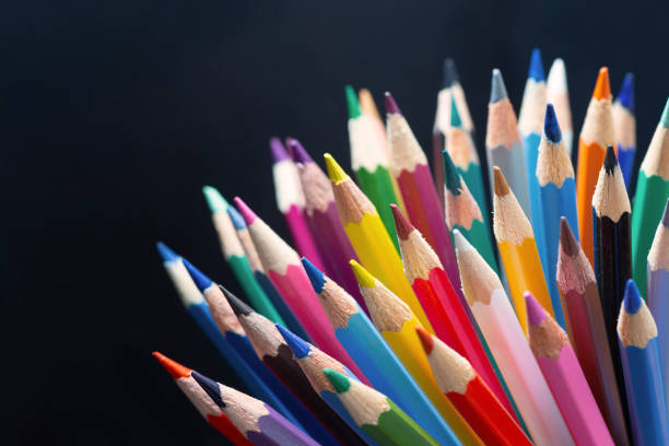 istock Colour pencils on black background close up 1265043512