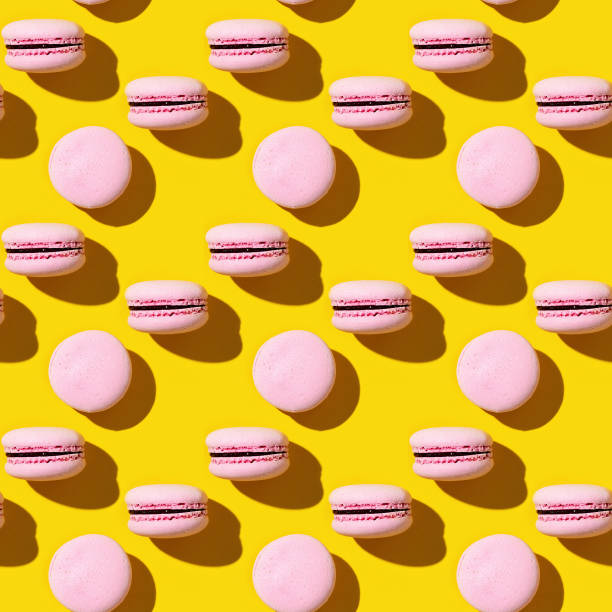 Seamless regular creative pattern of colorful french cookies macarons.