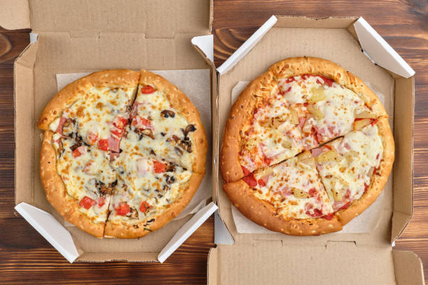istock Pizza carbonara and Hawaiian packaged for delivery with top view 1265045390