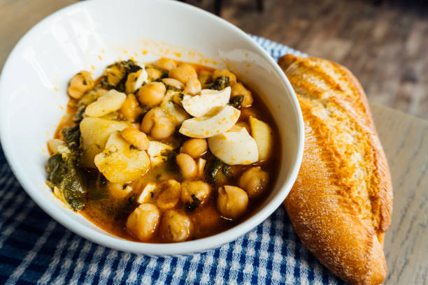istock Chickpea stew with chard, boiled egg and potatoes on a blue checkered tablecloth 1265045495