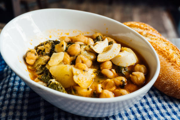 istock Chickpea stew with chard, boiled egg and potatoes on a blue checkered tablecloth 1265045522